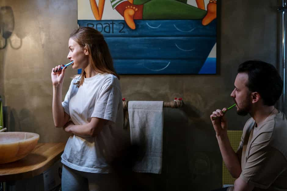 Husband and wife brushing their teeth